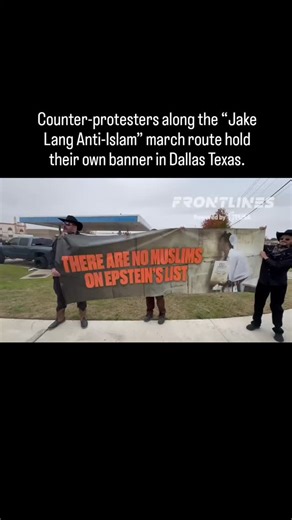 Counter-protesters along the “Jake Lang Anti-Islam” march route hold their own banner in Dallas Texas. | Texas For Palestine