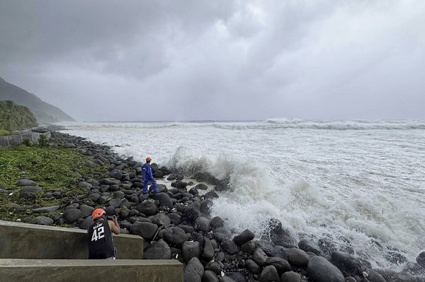 Super typhoon blowing by northern Philippines and Taiwan forces evacuations and closures