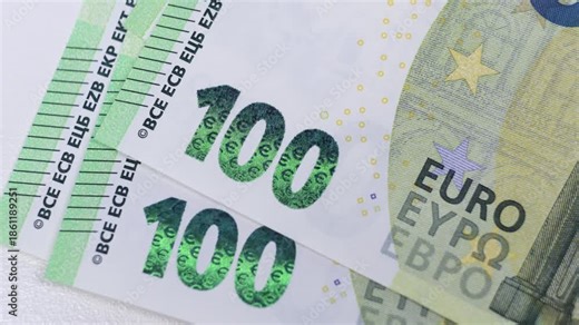Close-up sequence of euro banknotes showcasing intricate details and denominations as they are fanned out, revealing vibrant colors and security features in a smooth motion