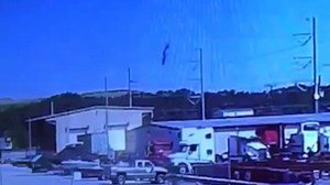 Surveillance video films military plane nose diving and exploding