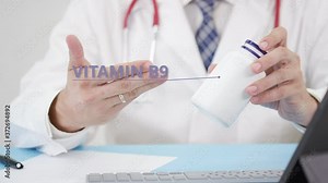 VITAMIN B9, a generic supplement, in the bottle in doctor's hand