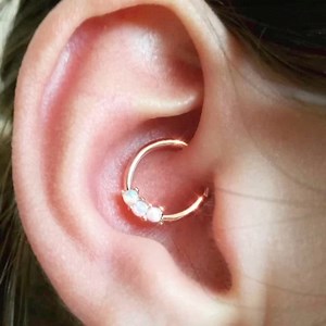 Opal Daith OBSESSED👂🏼✨ Shop now 🌸 https://www.bodycandy.com/search?view=spring&q=opal ring | Body Candy Body Jewelry