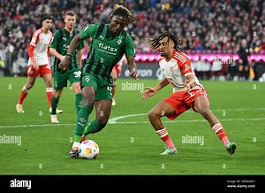 Munich, Germany. 03rd Feb, 2024. Soccer: Bundesliga, Bayern Munich - Borussia Mönchengladbach, Matchday 20, Allianz Arena. Munich's Sacha Boey (r) fights for the ball against Mönchengladbach's Manu Kone. Credit: Angelika Warmuth/dpa - IMPORTANT NOTE: In accordance with the regulations of the DFL German Football League and the DFB German Football Association, it is prohibited to utilize or have utilized photographs taken in the stadium and/or of the match in the form of sequential images and/or v
