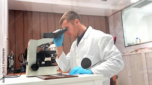 Doctor performing medical research with samples and microscope in the laboratory of an hospital
