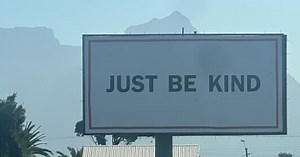 What's the meaning behind the 'Just Be Kind' billboards in Cape Town?