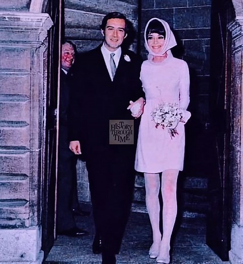 "On January 18, 1969, Audrey Hepburn and her second husband, Italian psychiatrist Dr. Andrea Dotti, were photographed on their wedding day in the snow-kissed village of Morges, Switzerland, where Hepburn had settled into quiet exile from Hollywood glamour. The ceremony, a civil service held at the town hall, was modest yet elegant—fitting for Hepburn’s refined sensibilities. She wore a pale pink wool mini-dress with matching tights and a funnel-neck coat by her longtime friend Hubert de Givenchy
