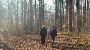 Older couple walking in the woods during the fall
