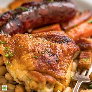 This comforting French Cassoulet recipe has juicy chicken, sausage, bacon and white beans that simmer away in a broth spiked with onion, garlic and herbs. Get the Recipe! >> https://keviniscooking.com/easy-french-cassoulet-recipe/ | Kevin Is Cooking