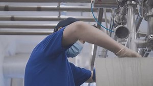 clip-1103345389-dairy-food-production-factory-male-worker-wearing