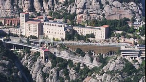 Aerial view of the Benedict church Abbey of Monserrat from Barcelona, Spain. Montserrat Monastery, Santa Maria de Montserrat is a Benedictine abbey located on the mountain of Montserrat