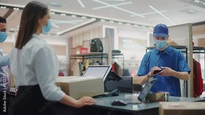 Clothing Store Checkout Counter: Retail Sales Managers wearing Protective Face Masks Give Package to Courier for Online Order Delivery. Trendy Designer Brands Available on Internet. Slow Motion