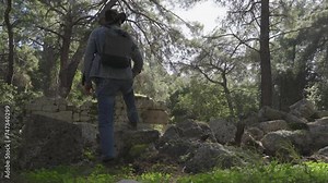 An archaeologist is a tourist in the jungle on the background of ancient ruins