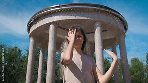 Upset teen suffer from hot weather. A sad teen with depressed emotions suffer from hot sun in the green park. A concept of climate changes period.