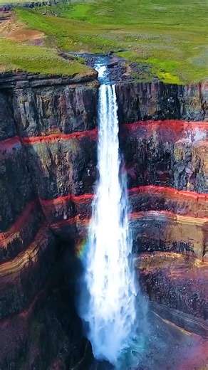 Hengifoss is the third tallest waterfall in Iceland, dropping 128 meters! 💦⛰️ But it's not just the height that stuns — the red clay and basalt rock layers give it a dramatic striped backdrop. Pro tip: The hike is 2.5 km each way — wear proper shoes and give yourself time to enjoy the views. 🥾 | Guide to Iceland