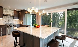 Spacious kitchen with large marble benchtops and calming color palette Stock Video