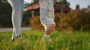 clip-3443008925-baby-first-steps-park-mother-teaches-son