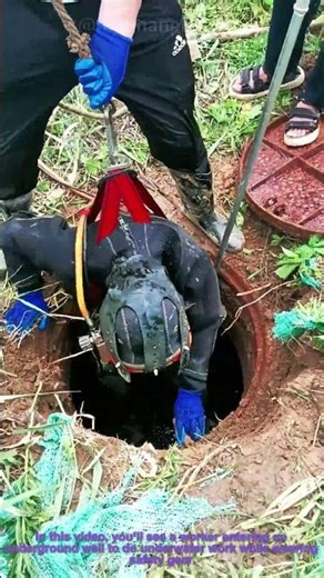 Underwater Sewer Work: Worker Enters Well With Safety Gear