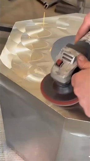 Using a hand grinder to smooth metal surfaces