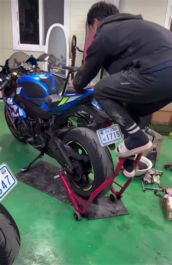 Getting your motorcycle up on a rear stand isn't that difficult. It can be nerve racking at first but once you have everything lined up it only takes a little pressure to push it down and get the bike up safely. I wish I knew just how much force but from my perspective it's not too much. especially when you use the leverage the stand provides. #motorcycle #bikerlife #tipsandtricks