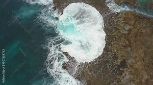 Overhead view of waves crashing onto rocky shore at Sharks cove Hawaii