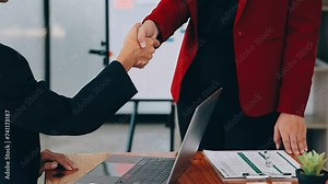 A woman playing a mobile phone by the window, a young businesswoman and a young executive founded a startup that has consistently made high profits. Concept of young businesswoman and startup company.