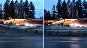 Video shows train dangling over highway after fatal derailment