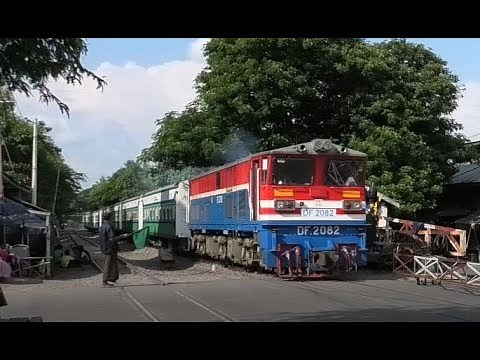 Myanmar Railways (Burma), a passenger train at a busy crossing, having exiting Mandalay Station.
