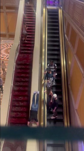 Man Slides Down Long Escalator Railing at Mall