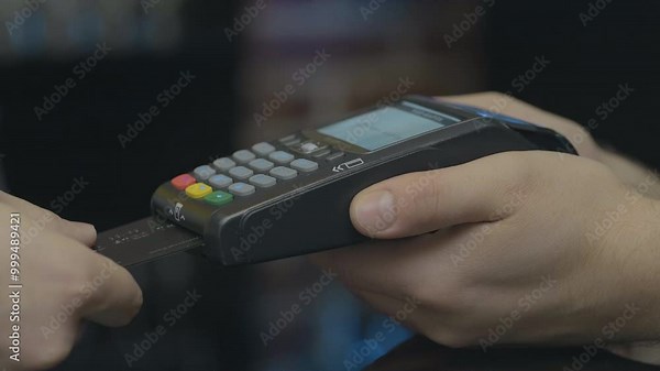 Credit card machine for money transaction. Man hand with credit card swipe through pos terminal and enter pin code. Banking services of electronic money. Financial success and safety.