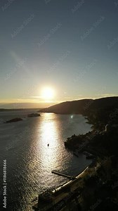 vertical smooth drone video of golden hour sunset light at Italian Lago Maggiore Piemont with the view to Isola Madre, l'Isola Bella e l'Isola dei Pescatori
