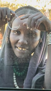 Arbore girls from Ethiopia's Omo Valley typically wear goatskin skirts decorated with colorful beads and shells. They adorn themselves with multiple necklaces, bracelets, and metal earrings. They often cover their hair with beads and style it with butter mixed with ash, creating a distinctive look that reflects their cultural identity. #inspirationofafrica | Quim Fàbregas