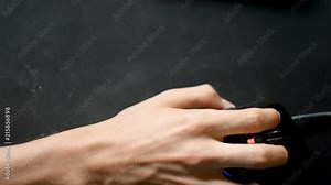 Top-down view of computer gamer hand using mouse while playing videogames on PC