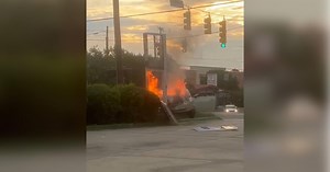 Driver crashes into Mobil gas station sign in Durham, causing car to catch fire