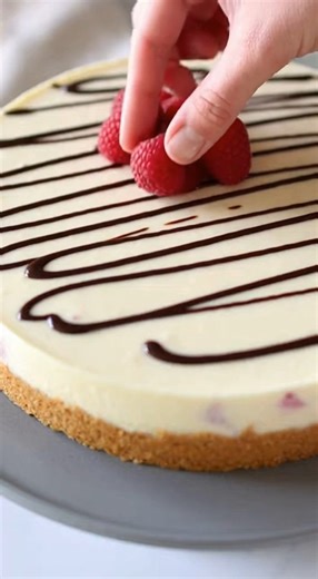 No-Bake White Chocolate Raspberry Cheesecake You Will Need: 2½ cups graham cracker crumbs ½ cup unsalted butter, melted 2 tablespoons sugar (optional, for added sweetness) Instructions: Prepare the Crust: Mix graham cracker crumbs, melted butter, and sugar (if using) together. Press this mixture into the bottom of your cheesecake pan to form a crust. Set aside to chill while you prepare the filling. Make the Filling: Prepare a no-bake cheesecake filling using white chocolate and your preferred c