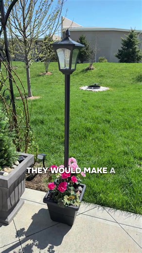 Solar lamp post with warm tone, lightbulb, and flower basket