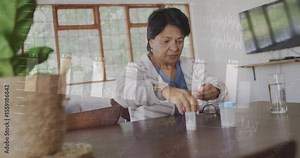 Senior woman grabbing pill bottle and pouring tablets as animated health bar chart updating