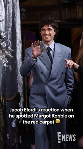 The finger wave. 🥹 Jacob Elordi was all smiles spotting costar Margot Robbie at the "Wuthering Heights" Australian premiere. | E! News