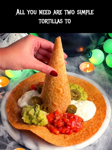 🧙‍♀️🎃 Crunchy Witch Hat Tortilla Chips! A little spooky, a little crunchy, and totally dip-worthy! 💚✨ The cutest Halloween party snack! 🛒 Ingredients - Large flour tortillas - Cooking spray or olive oil - Salt or taco seasoning - Guacamole - Salsa - Sour cream - Sliced jalapeños 👩‍🍳 Instructions 1. Roll it! Cut a tortilla into a semicircle, roll into a cone, and secure the seam. 2. Cut it! Cut a circle from another tortilla for the hat brim. 3. Bake it! Lightly oil and season both pieces. 