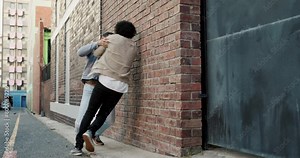 City, violence and men in street fight with conflict, battle and disagreement with aggression, punching and drama. Argument, bullying and angry friends in urban brawl in alley with frustrated danger