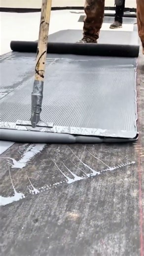 Spread the poured cement mixture using a screed on the foundation floor surface for renovation