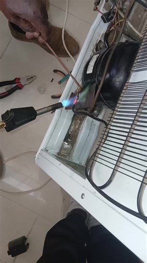 non frost fridge compressor mounting and gas refill. we are the tech...