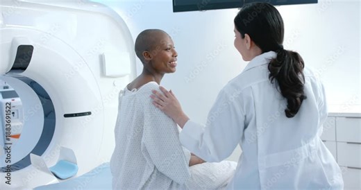 Female doctor placing hand on patient at exam table near scanner, reassuring, patient smiling