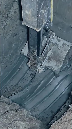Workers digging a well come across blue clay