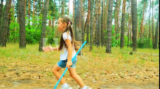 little girl with a butterfly net. a child runs with a butterfly net in the park through a nature forest in summer catches insects. happy family kid dream concept. baby play in the summer fun run