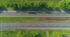 Road with cars top view. Highway outside the city, fields at the edges of the road