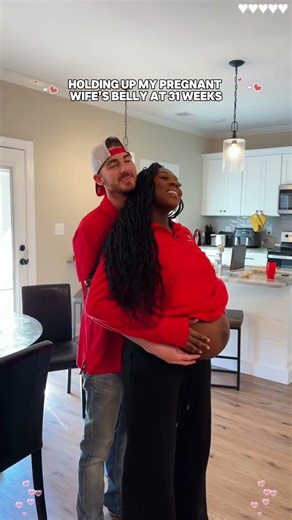 Holding up my pregnant wife's belly##foryou #love #pregnant #couple