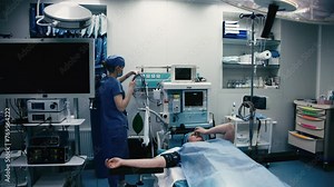 In the operating room, the surgical team prepares the patient for surgery. High tech medical technology, modern medicine, futuristic medical equipment, operation.