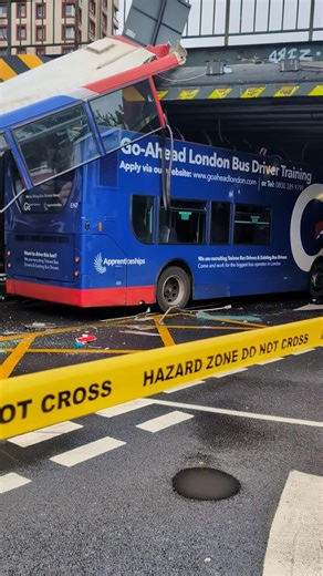 The roof of a double decker bus has been torn off after it crashed into a railway bridge | The Mirror