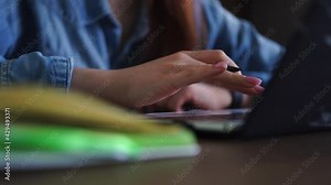 Office worker, writes notes pen paper notebook, types laptop keyboard. Engaged in online education during pandemic. Studying new material, writing down useful information paper. Modern education