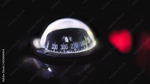 Marine compass on a sailing yacht at night. Backlit compass